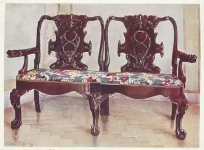 Carved walnut darby and Joan settee av Edwin Foley