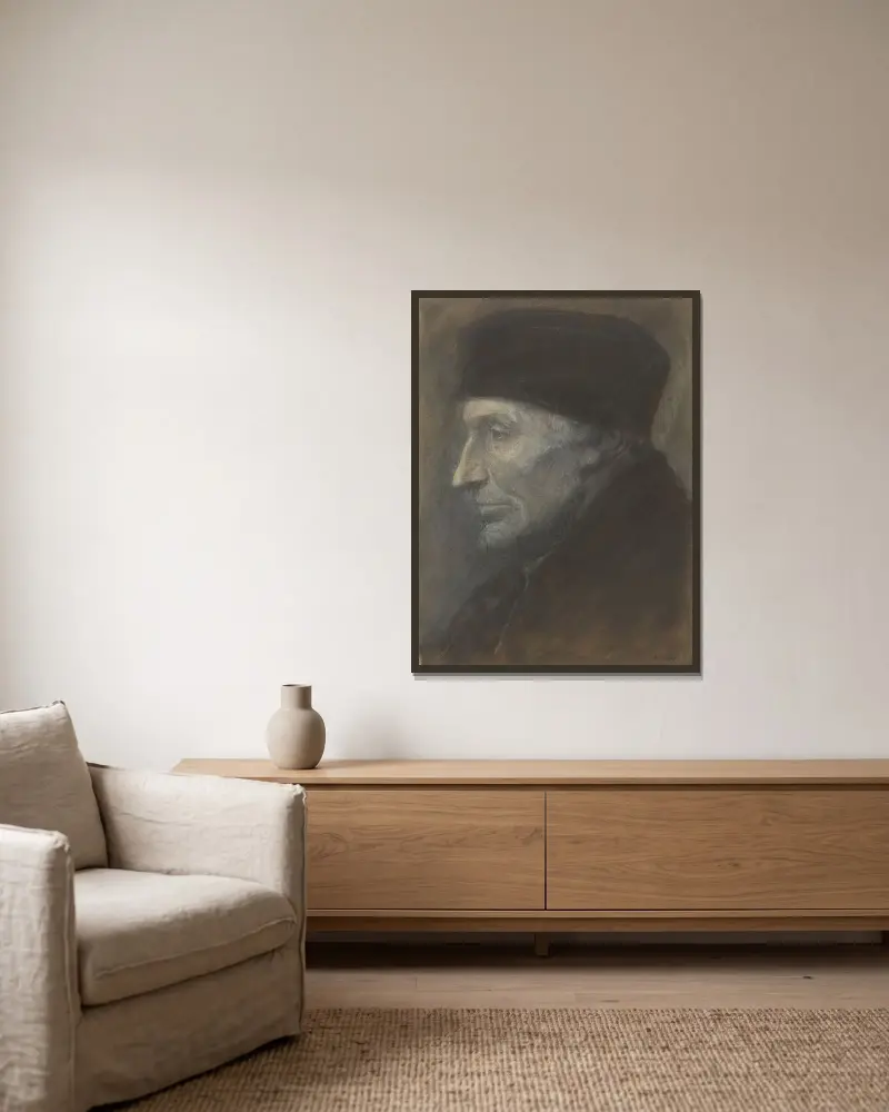 Manshuvud med skallmössa av Alphonse Legros inramad på en vägg