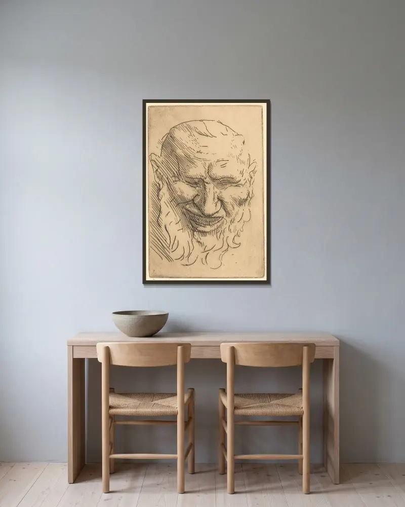 Liten satyrmask av Alphonse Legros inramad på en vägg