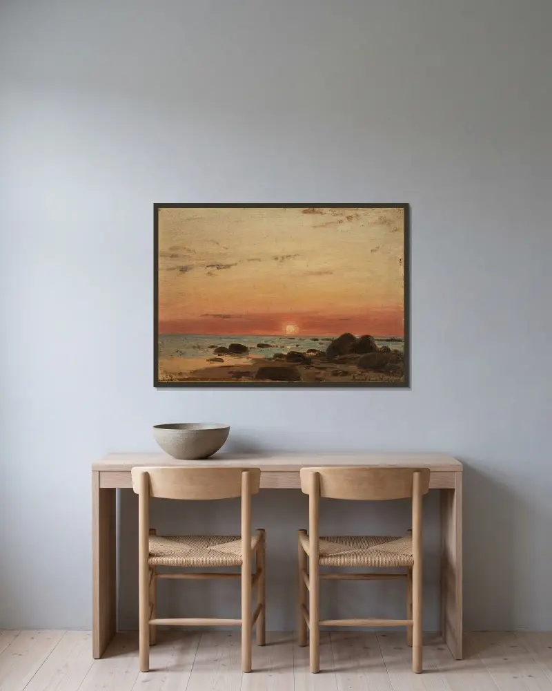 Solnedgång av Amaldus Nielsen inramad på en vägg