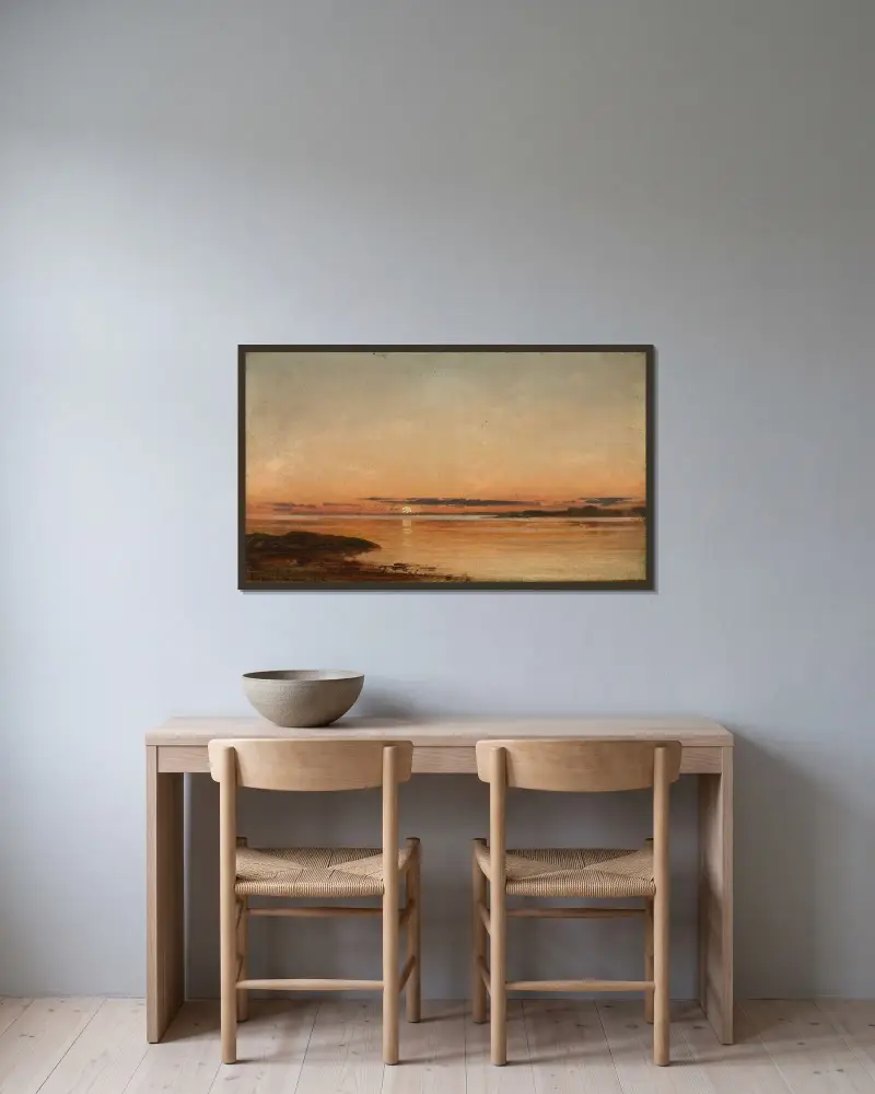 Solnedgång vid Fredrikstad av Amaldus Nielsen inramad på en vägg