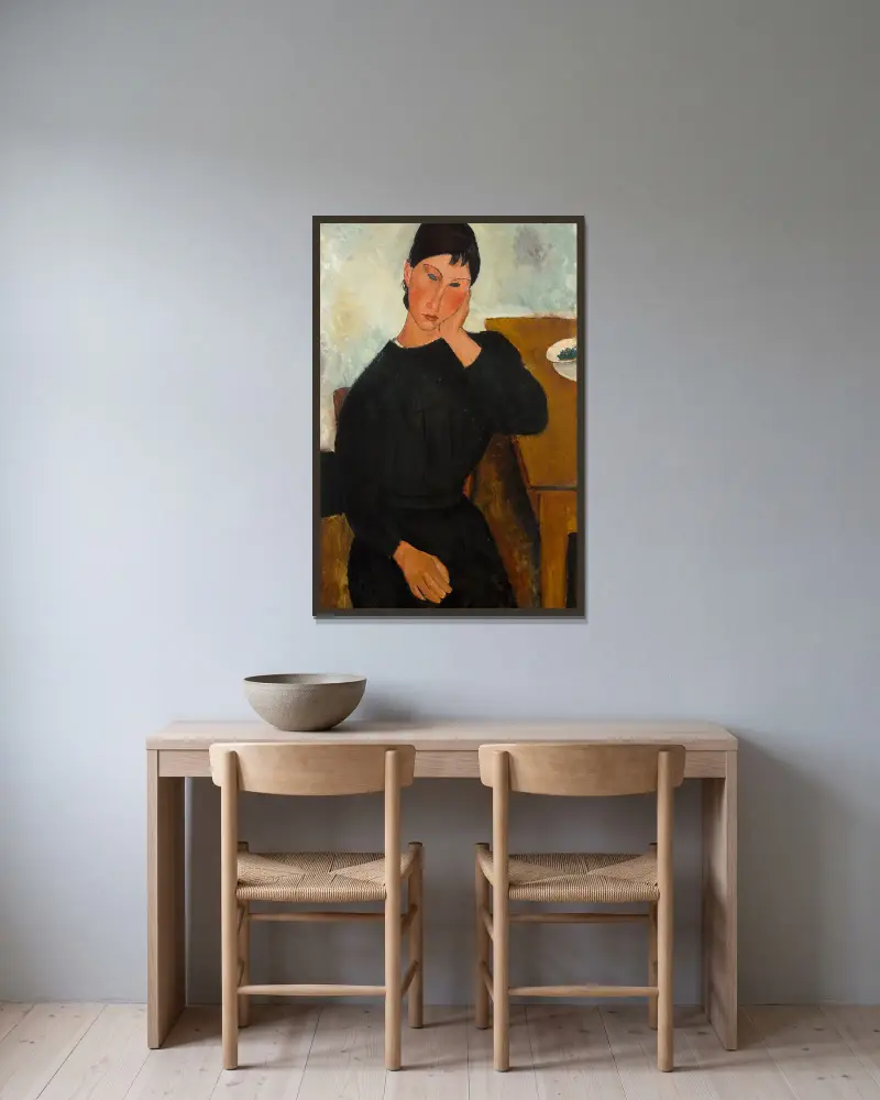 Elvira, an einem Tisch ruhend von Amedeo Modigliani gerahmt an einer Wand