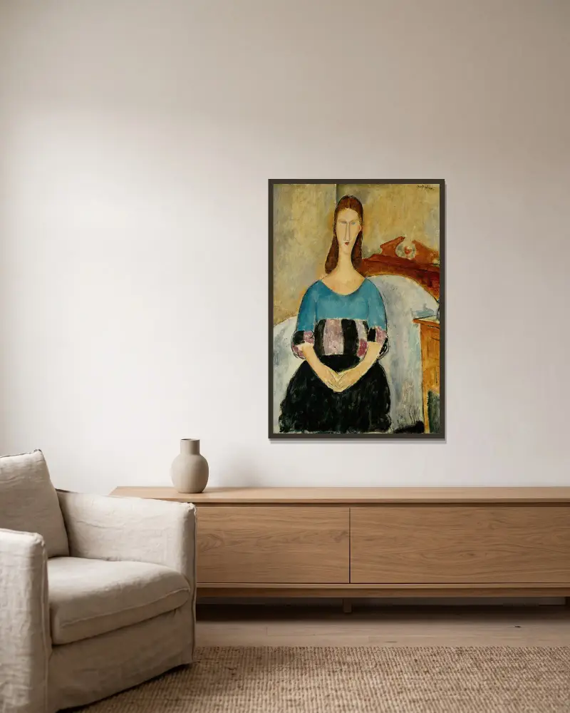 Portrait of Jeanne Hebuterne, Seated av Amedeo Modigliani inramad på en vägg