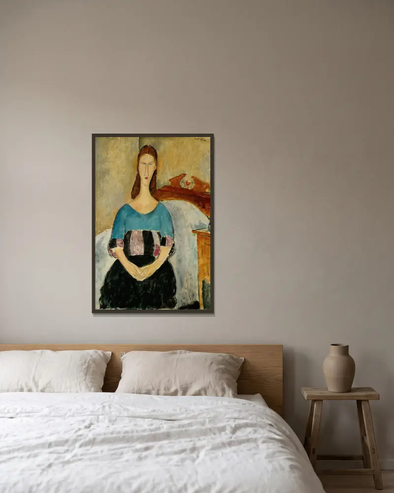 Portrait of Jeanne Hebuterne, Seated av Amedeo Modigliani inramad på en vägg