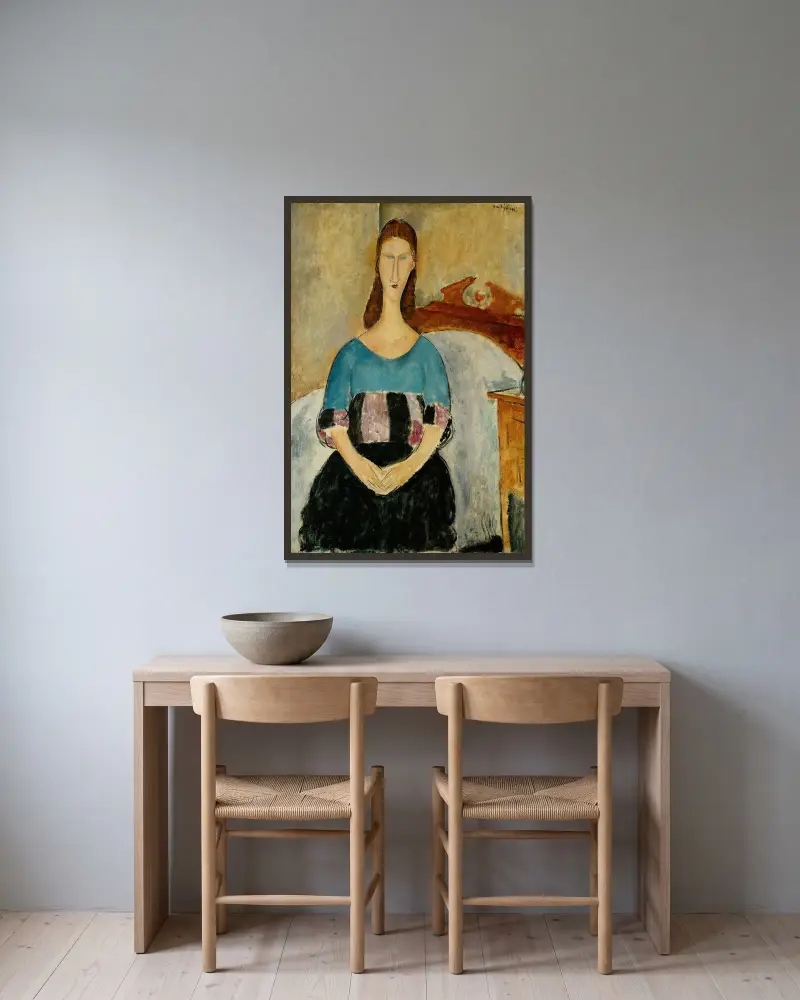 Portrait of Jeanne Hebuterne, Seated av Amedeo Modigliani inramad på en vägg