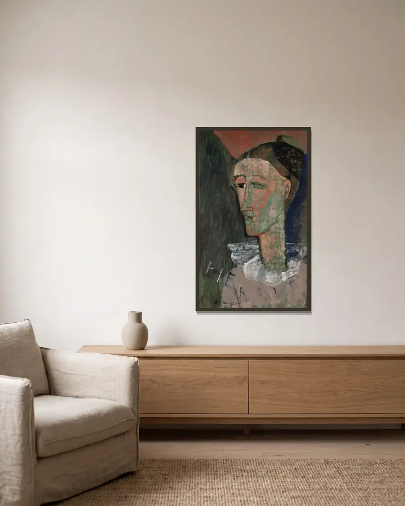 Selbstbildnis als Pierrot von Amedeo Modigliani gerahmt an einer Wand
