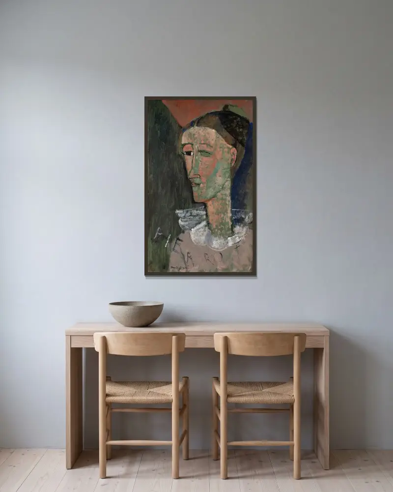 Selbstbildnis als Pierrot von Amedeo Modigliani gerahmt an einer Wand