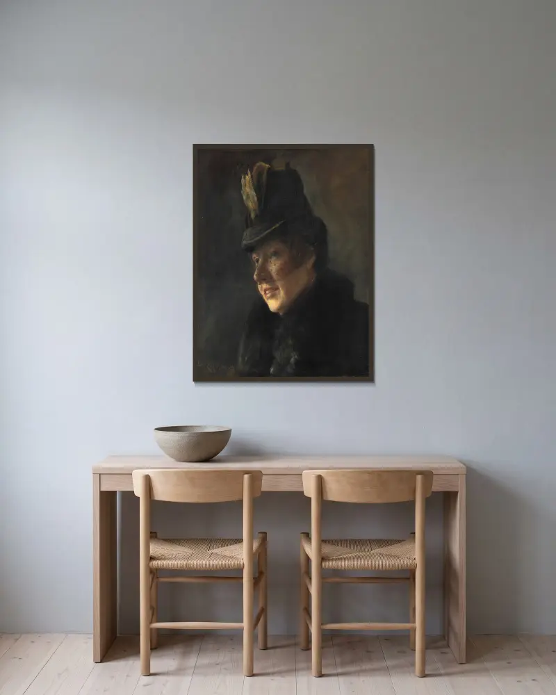 Portræt af en ung kvinde i frakke med pelskrave og hat med slør av Laurits Andersen Ring inramad på en vägg