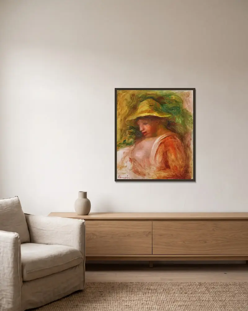 Femme Au Chapeau av Pierre-Auguste Renoir inramad på en vägg
