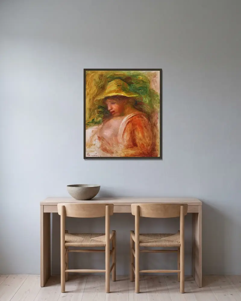 Femme Au Chapeau av Pierre-Auguste Renoir inramad på en vägg