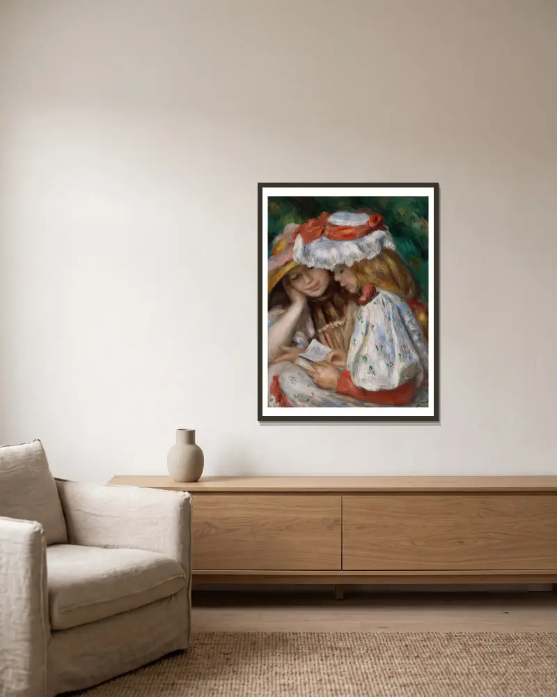 Zwei lesende Mädchen von Pierre-Auguste Renoir gerahmt an einer Wand