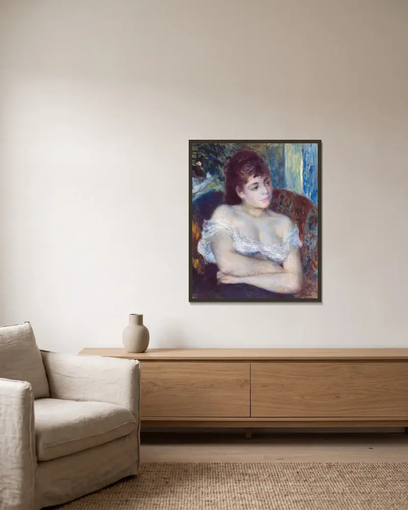 Woman in an Armchair av Pierre-Auguste Renoir inramad på en vägg