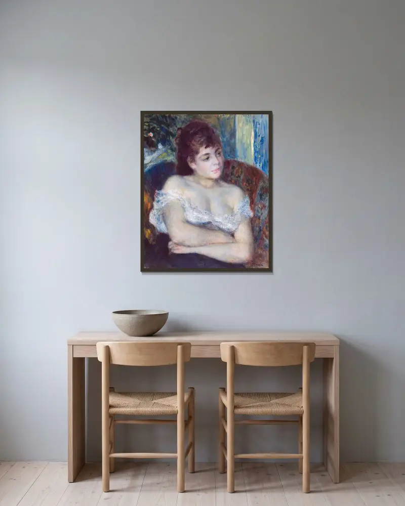Woman in an Armchair av Pierre-Auguste Renoir inramad på en vägg