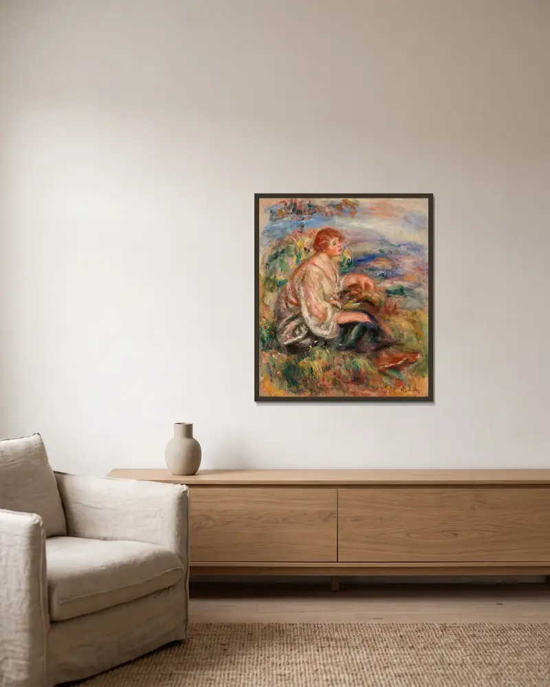 Kvinna i tyllblus och svart kjol i landskap av Pierre-Auguste Renoir inramad på en vägg