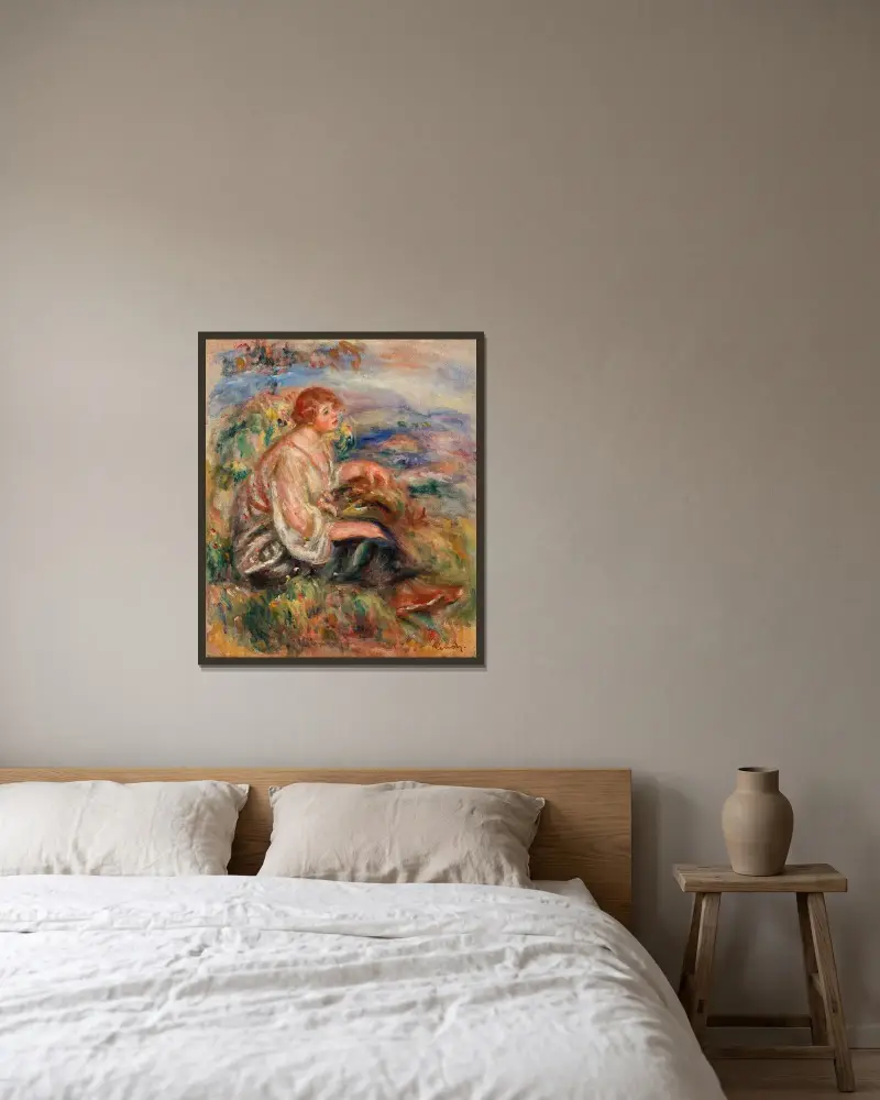 Kvinna i tyllblus och svart kjol i landskap av Pierre-Auguste Renoir inramad på en vägg