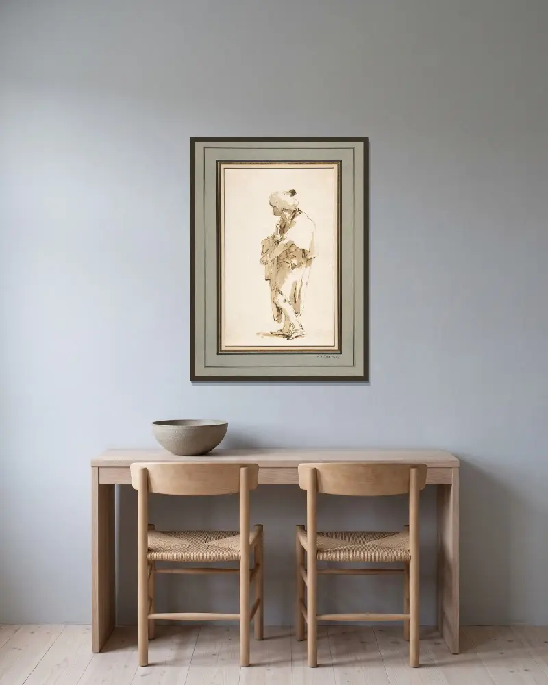 Stående man i turban, hållande ett svärd av Giovanni Battista Tiepolo inramad på en vägg