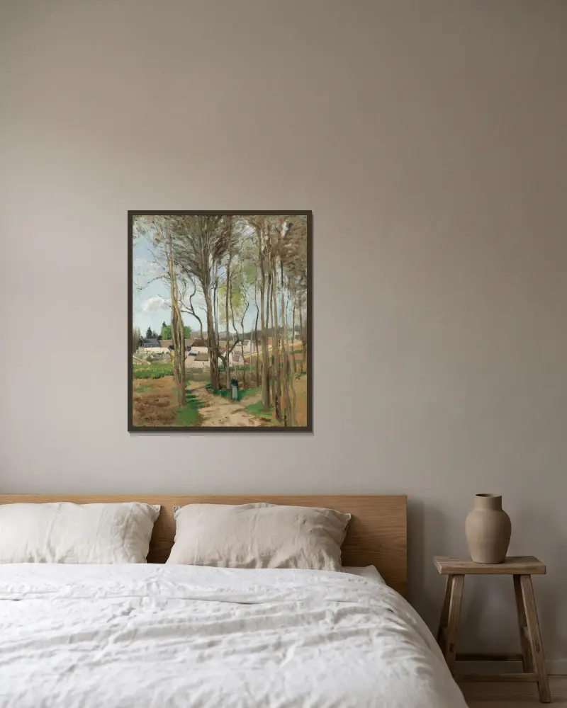 Le village à travers les arbres av Camille Pissarro inramad på en vägg