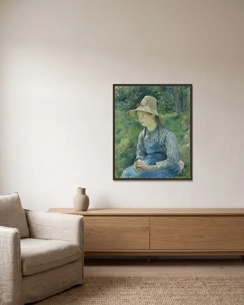 Peasant Girl with a Straw Hat av Camille Pissarro inramad på en vägg
