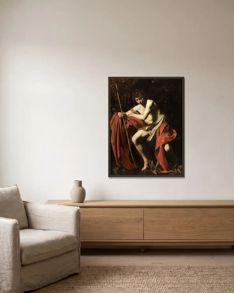 Saint John The Baptist In The Wilderness av Caravaggio inramad på en vägg