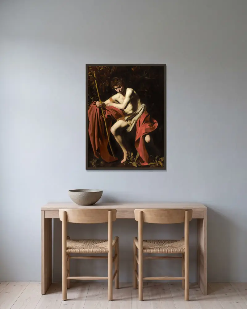 Saint John The Baptist In The Wilderness av Caravaggio inramad på en vägg