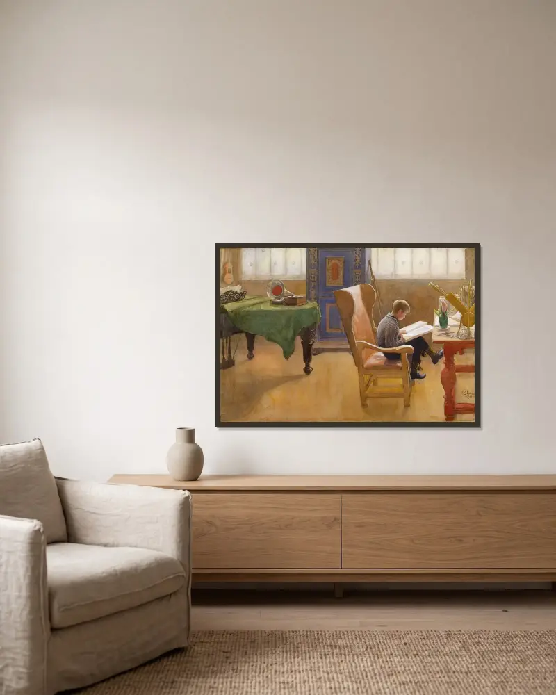 Esbjörn am Schreibtisch von Carl Larsson gerahmt an einer Wand