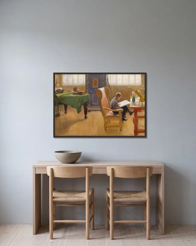 Esbjörn am Schreibtisch von Carl Larsson gerahmt an einer Wand