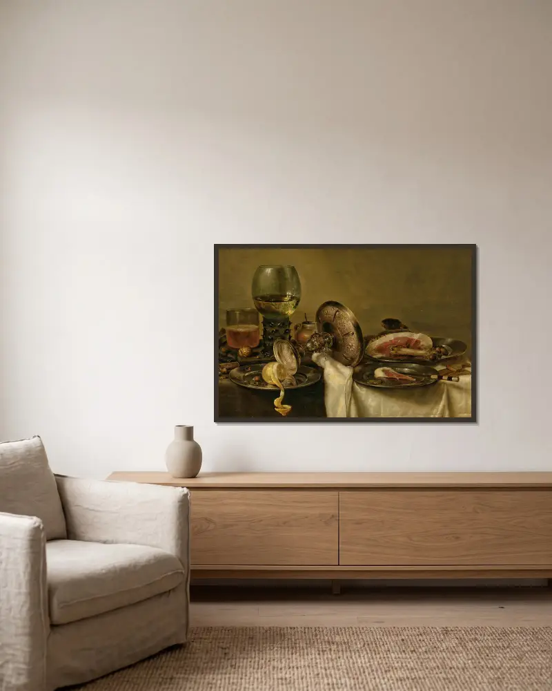 Ett delvis draperat bord med en omkullvält tazza, roemer och glasöl, med en delvis skalad citron och skinka på tenntallrikar av Willem Claesz Heda inramad på en vägg