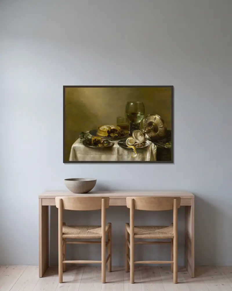 A still life with an overturned silver tazza, glassware, pies and a peeled lemon on a table av Willem Claesz Heda inramad på en vägg