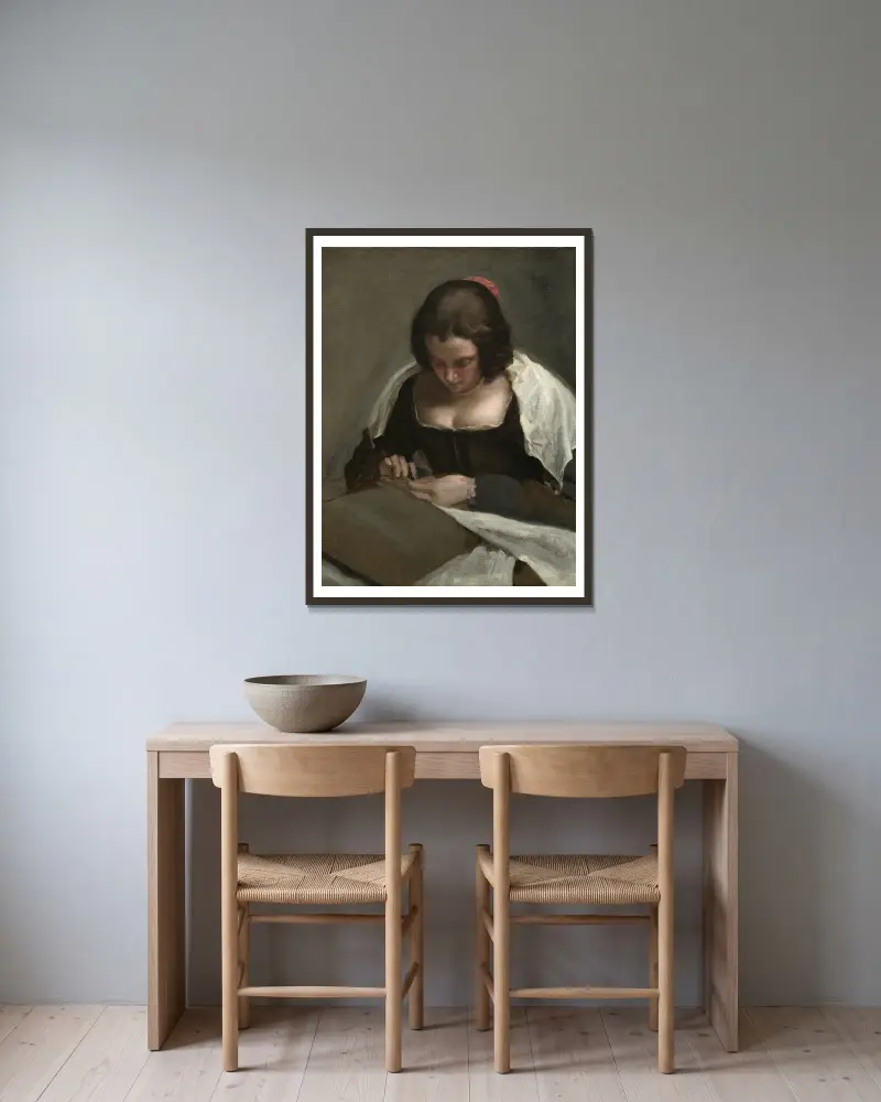 The Needlewoman av Diego Velázquez inramad på en vägg