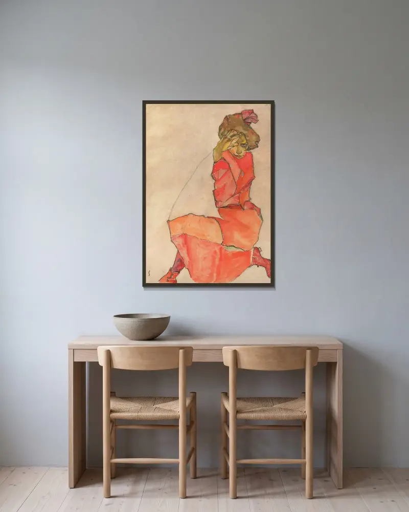 Kneeling Female in Orange-Red Dress av Egon Schiele inramad på en vägg