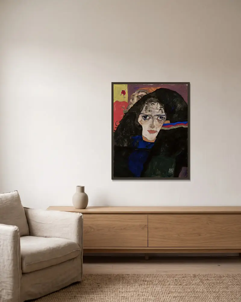 Trauernde Frau von Egon Schiele gerahmt an einer Wand