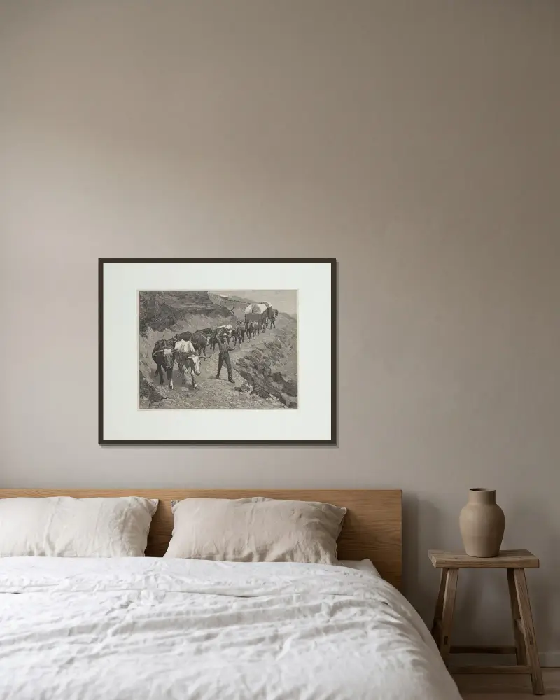 En oxskjuts i bergen av Frederic Remington inramad på en vägg