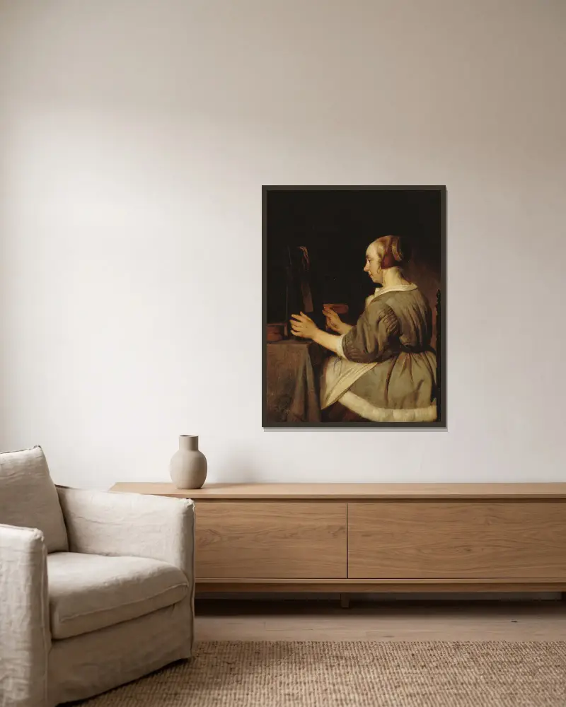 Femme au miroir av Gabriel Metsu inramad på en vägg