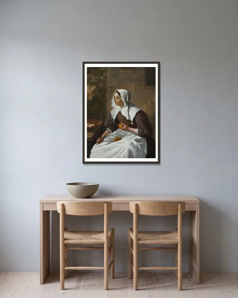 Mädchen beim Äpfelschälen von Gabriel Metsu gerahmt an einer Wand