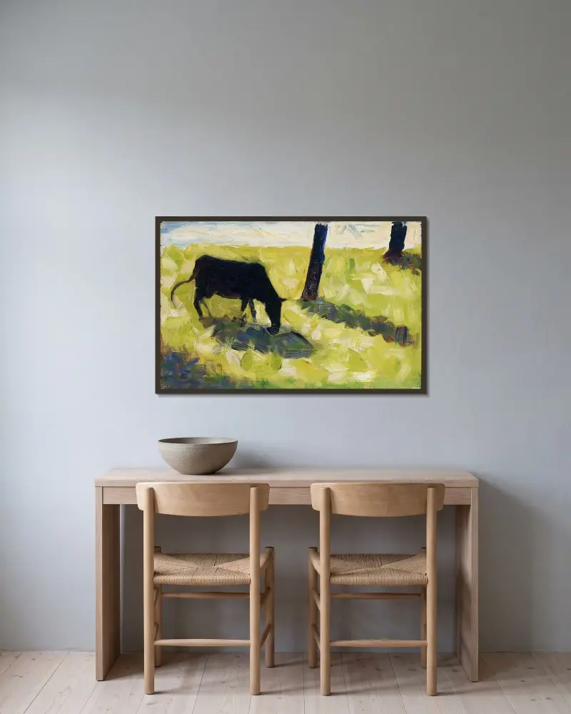 Black Cow in a Meadow av Georges Seurat inramad på en vägg