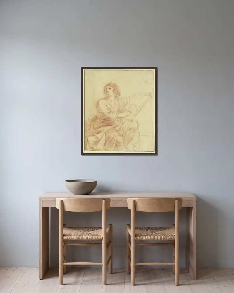 Johannes evangelisten, sittande och skrivande av Guercino inramad på en vägg