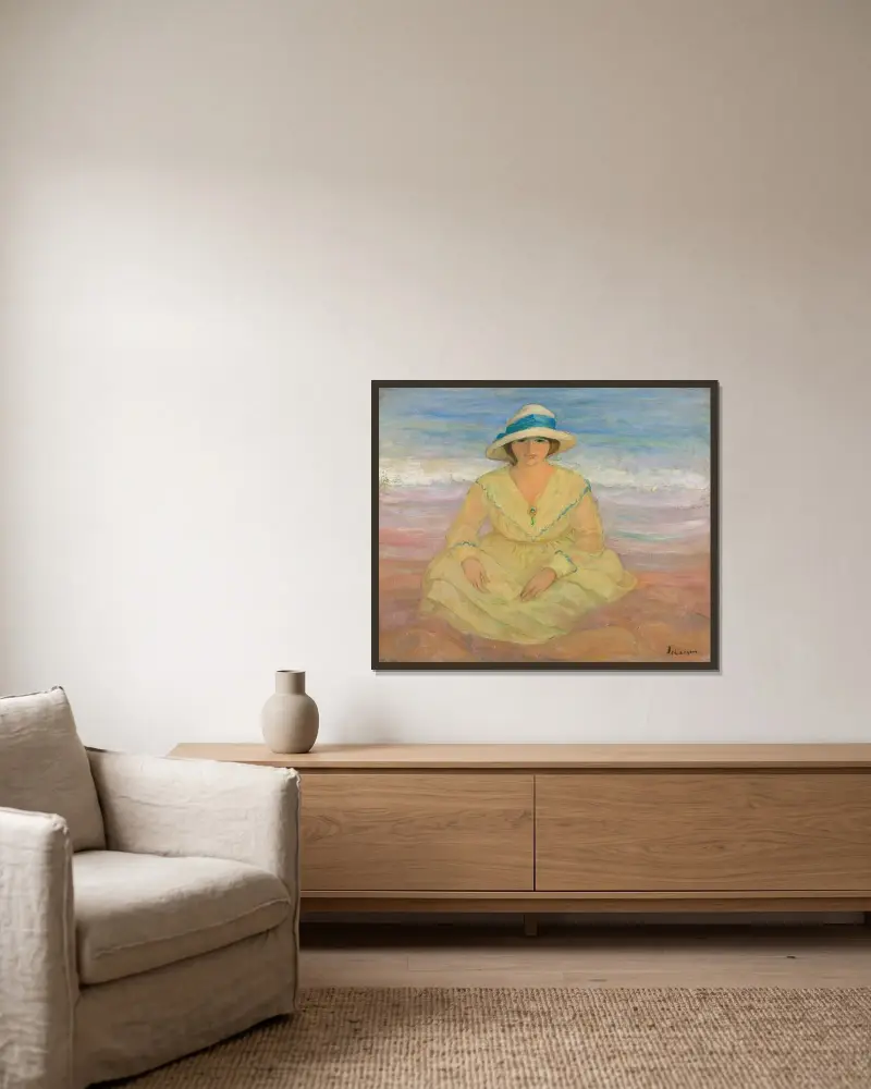 Ung flicka sittande på stranden av Henri Lebasque inramad på en vägg