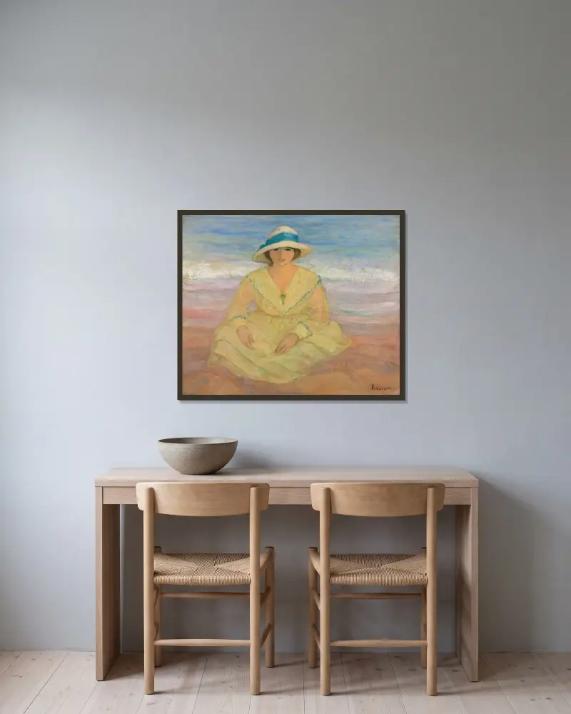 Ung flicka sittande på stranden av Henri Lebasque inramad på en vägg