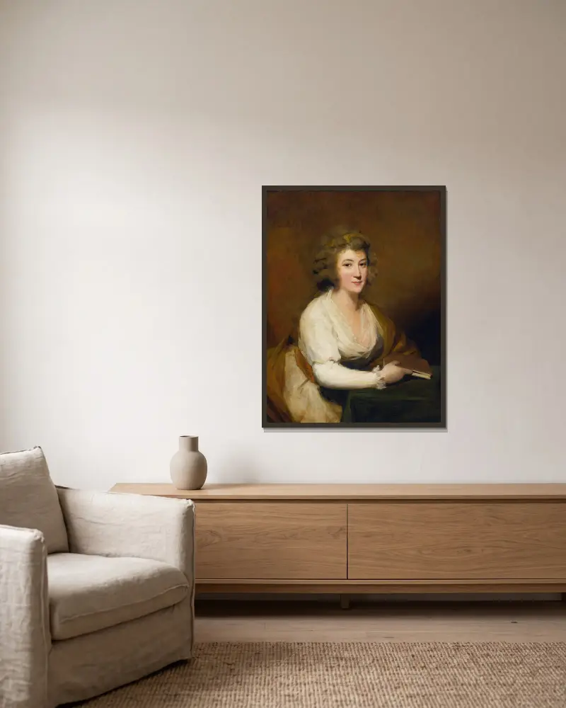 Porträtt av Lady Nasmyth, i vit klänning och brun sjal, sittande vid ett bord med en bok av Sir Henry Raeburn inramad på en vägg