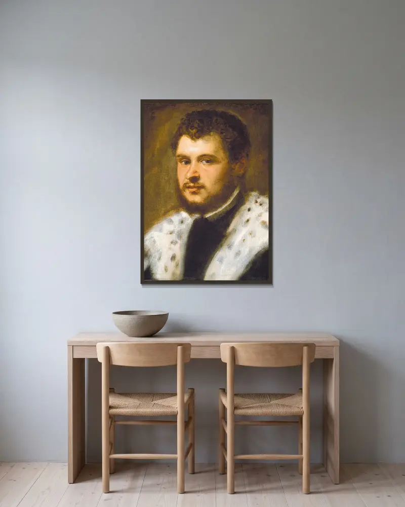 Junger Mann mit Bart von Jacopo Tintoretto gerahmt an einer Wand