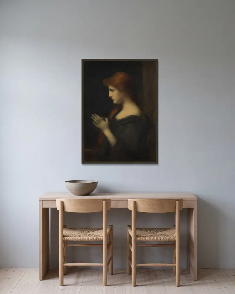 Ung kvinna i bön av Jean-Jacques Henner inramad på en vägg