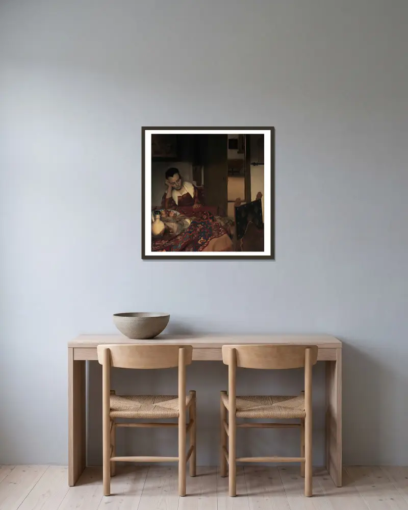 A Maid Asleep av Johannes Vermeer inramad på en vägg