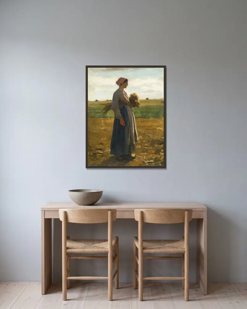 Ung kvinna på fälten av Jules Breton inramad på en vägg