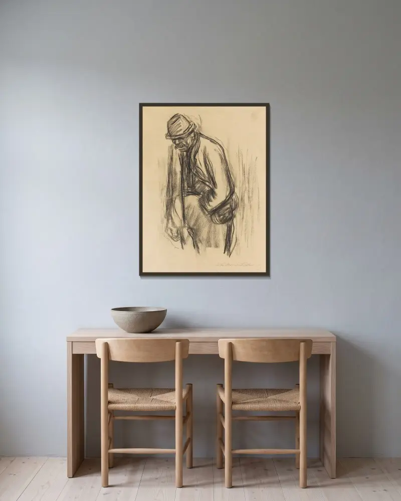 Mann mit Hut von Käthe Kollwitz gerahmt an einer Wand