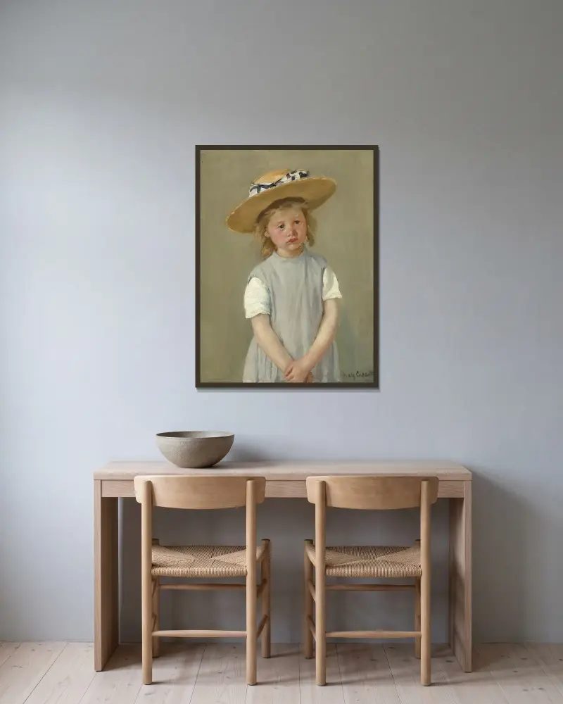 Child in a Straw Hat av Mary Cassatt inramad på en vägg