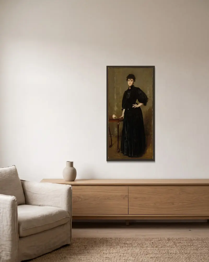 Dam i svart av William Merritt Chase inramad på en vägg