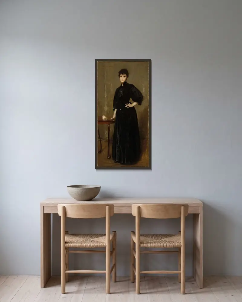 Dam i svart av William Merritt Chase inramad på en vägg