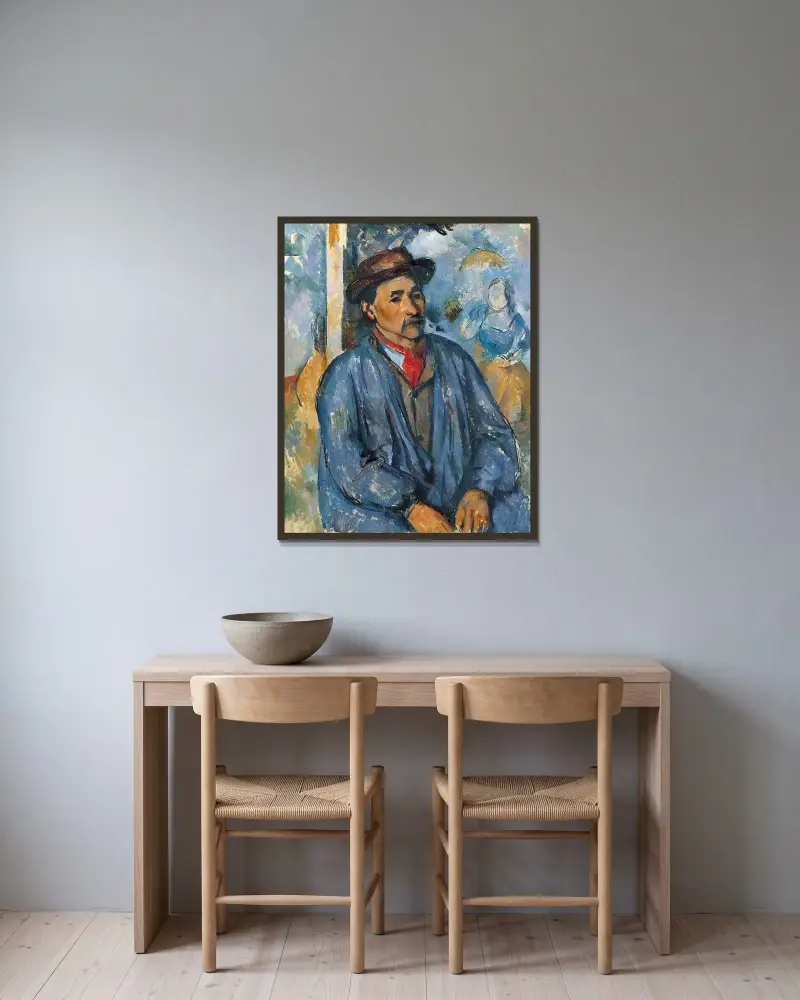 Mann im blauen Arbeitskittel von Paul Cézanne gerahmt an einer Wand
