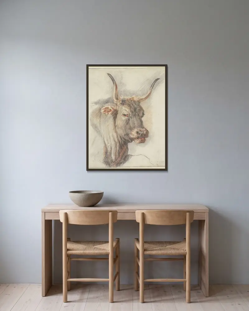 Ein Ochsenkopf von Paulus Potter gerahmt an einer Wand
