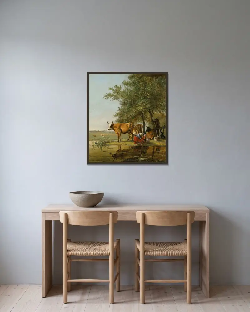 Landskap med boskap och en kvinna som rengör en hink vid en bäck av Paulus Potter inramad på en vägg